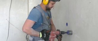 drilling a hole for socket boxes in a concrete wall